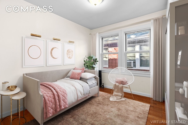 945 E 32nd St, New York City, NY 11210 - bedroom featuring wood finished floors and baseboards