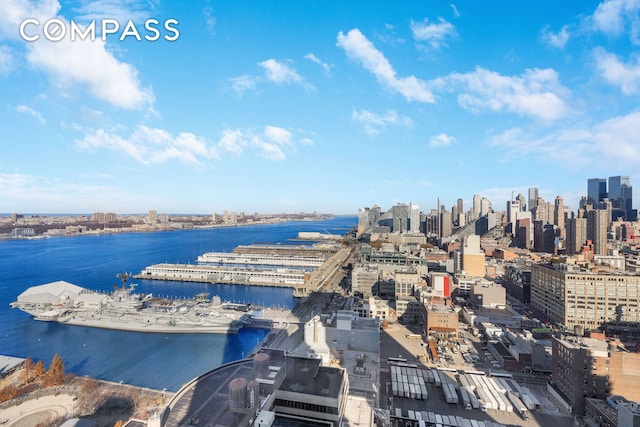 birds eye view of property with a water view and a city view