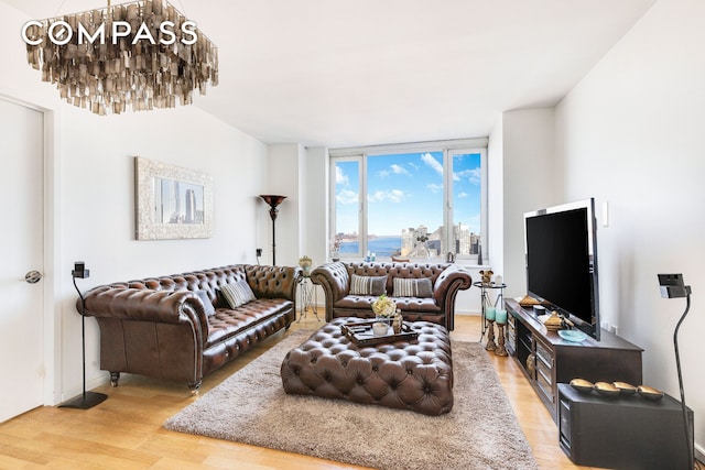 living area with an inviting chandelier and light wood-style floors