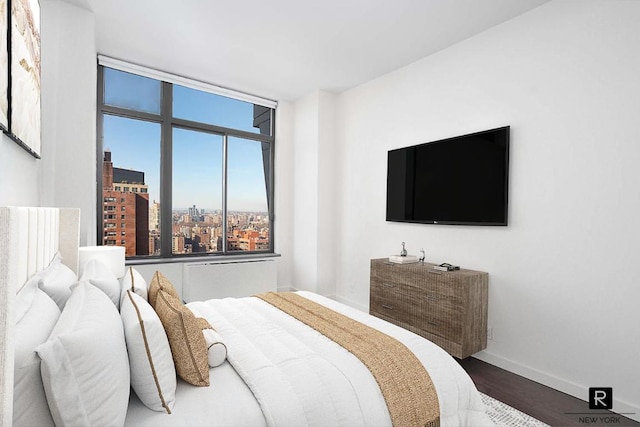 bedroom featuring wood finished floors and baseboards