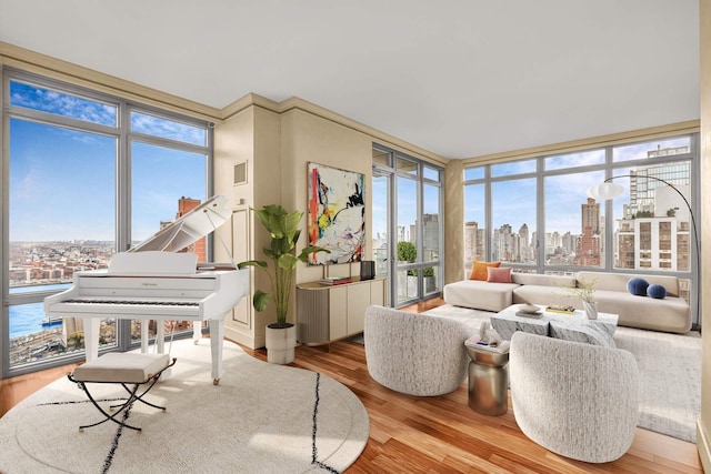 sunroom featuring a healthy amount of sunlight, a view of city, and visible vents