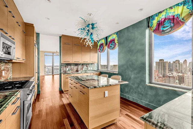 333 E 91st St Unit 31Cd, New York City, NY 10128 - kitchen featuring stainless steel appliances, light wood finished floors, plenty of natural light, a center island, and recessed lighting