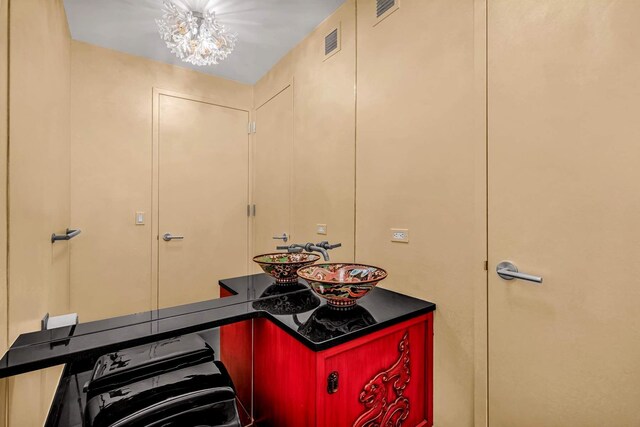 333 E 91st St Unit 31Cd, New York City, NY 10128 - bathroom featuring a chandelier and a sink