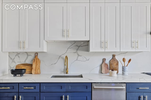 kitchen with white cabinets, blue cabinets, and a sink