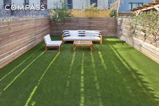 view of yard with a fenced backyard and outdoor lounge area