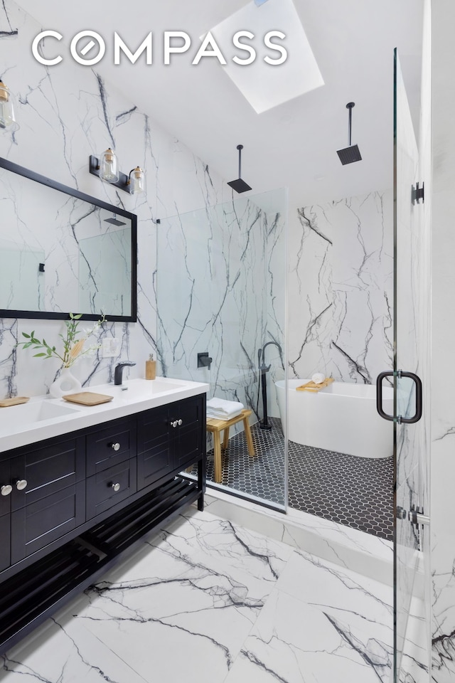 full bath featuring double vanity, stone wall, a marble finish shower, and a sink