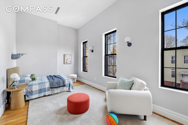 bedroom with wood finished floors and baseboards