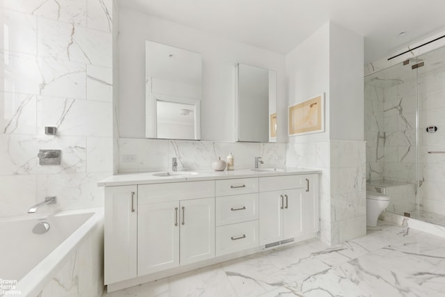 317 W 89th St Unit 9W, New York City, NY 10024 - full bathroom with tile walls, double vanity, a marble finish shower, a tub to relax in, and marble finish flooring