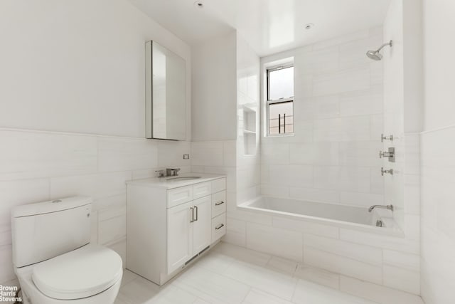 317 W 89th St Unit 9W, New York City, NY 10024 - bathroom featuring vanity, tiled shower / bath combo, and tile walls