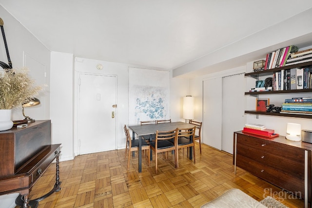 dining area featuring light parquet floors