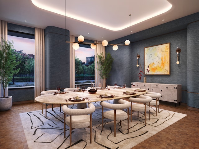 dining area with a tray ceiling and a wall of windows