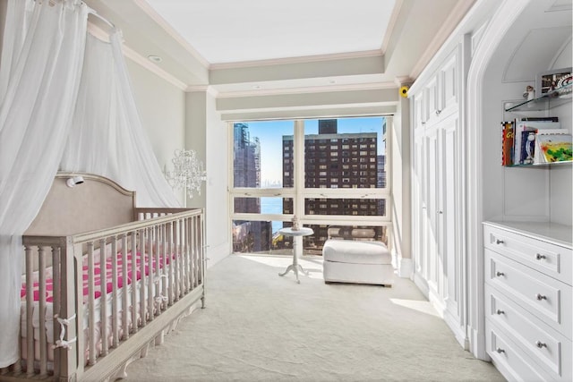 carpeted bedroom featuring crown molding and a crib