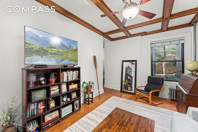 office area with beam ceiling, radiator, a ceiling fan, coffered ceiling, and baseboards