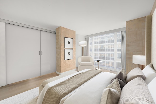 bedroom with light wood-style floors and a closet