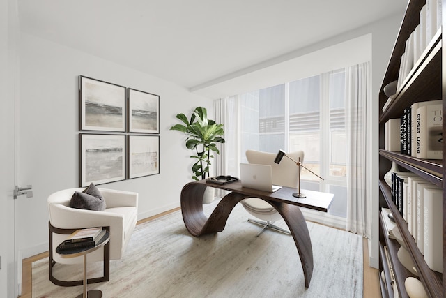 office featuring baseboards and light wood finished floors