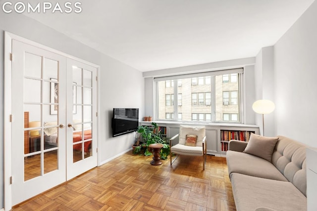 sitting room featuring french doors and light parquet floors