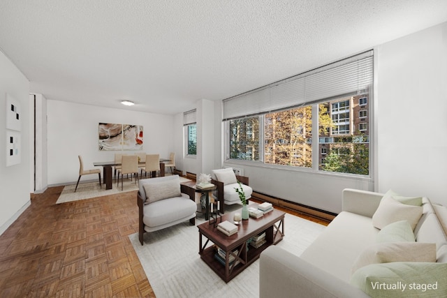 living room with parquet flooring and a textured ceiling