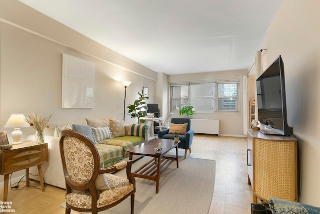 living room with light parquet flooring and radiator heating unit