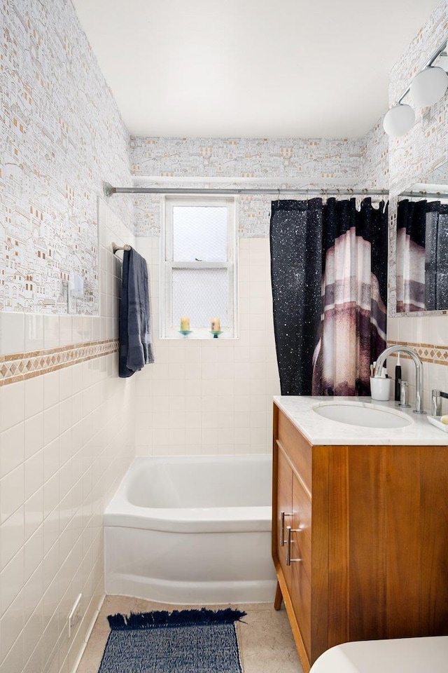 full bath featuring tub / shower combination, tile walls, and vanity