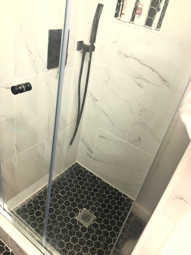 full bath featuring a shower stall