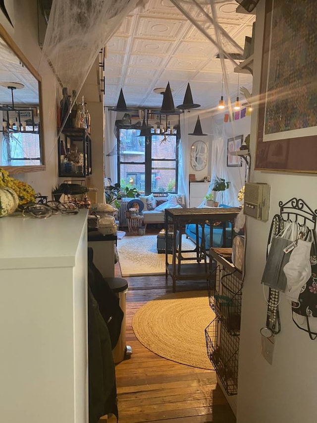 kitchen featuring an ornate ceiling and wood-type flooring