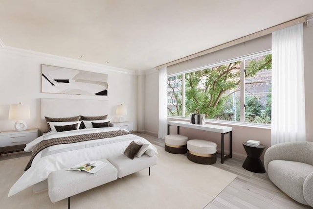 bedroom featuring ornamental molding and light hardwood / wood-style floors