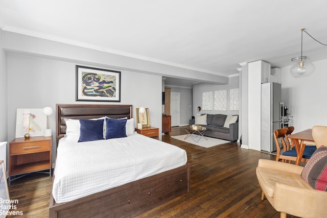 bedroom with crown molding, baseboards, freestanding refrigerator, and hardwood / wood-style flooring
