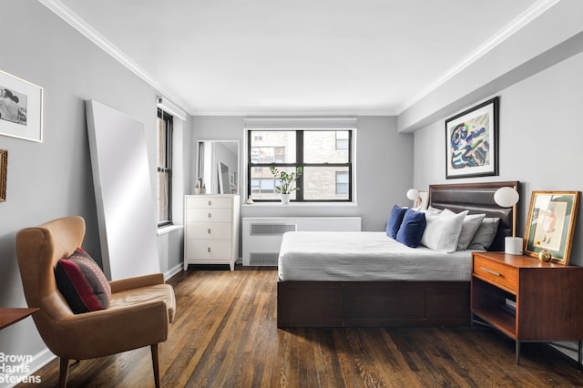 bedroom featuring ornamental molding, dark wood-type flooring, and radiator heating unit