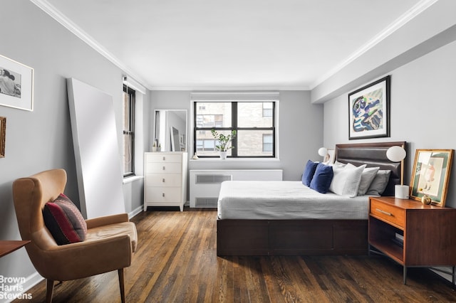 bedroom featuring crown molding, radiator, baseboards, and dark wood finished floors