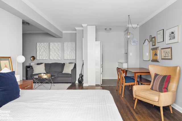 bedroom featuring wood finished floors, freestanding refrigerator, baseboards, and ornamental molding
