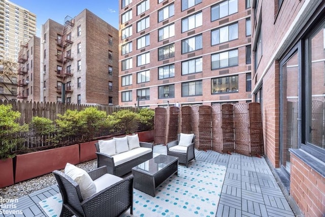 view of patio featuring outdoor lounge area and fence