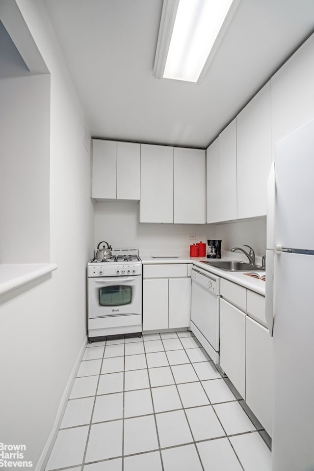 kitchen with light tile patterned flooring, white appliances, a sink, white cabinets, and light countertops