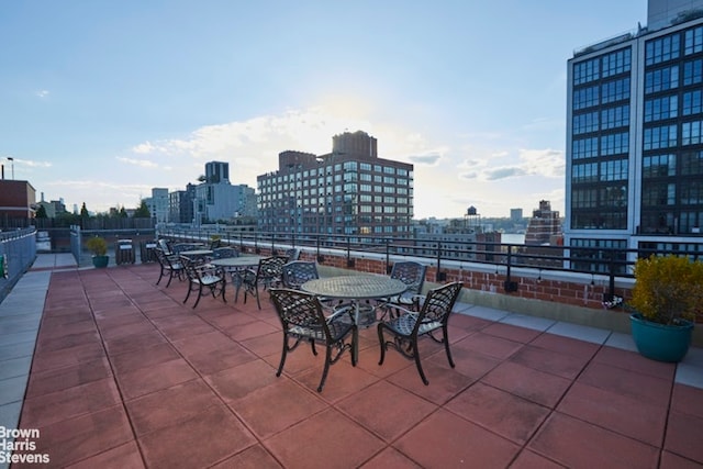 view of patio / terrace with a view of city and outdoor dining space