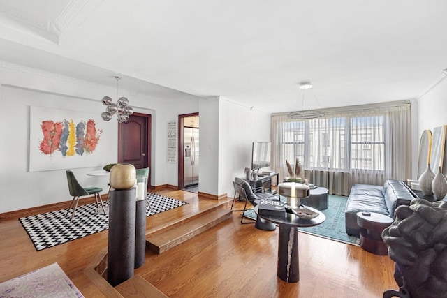 living room featuring baseboards, crown molding, an inviting chandelier, and wood finished floors