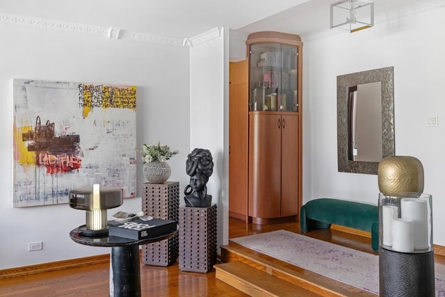 living area featuring baseboards and wood finished floors