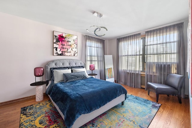 bedroom with wood finished floors and baseboards