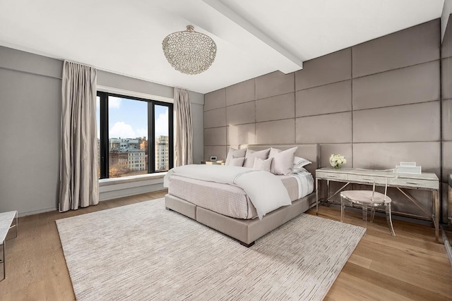 bedroom featuring light wood-type flooring and tile walls