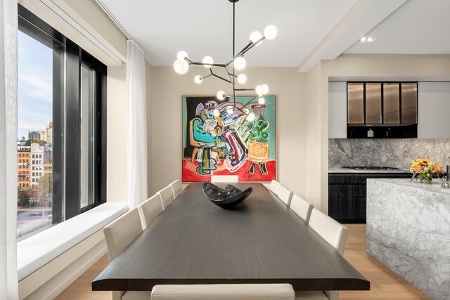 home office featuring light hardwood / wood-style floors and a tray ceiling