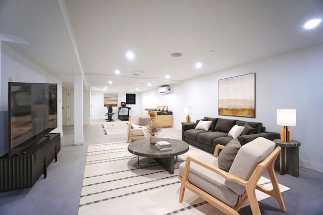 living room with a wall unit AC, baseboards, and recessed lighting