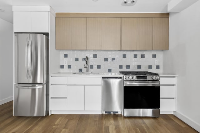 kitchen featuring visible vents, stainless steel appliances, a sink, and light countertops