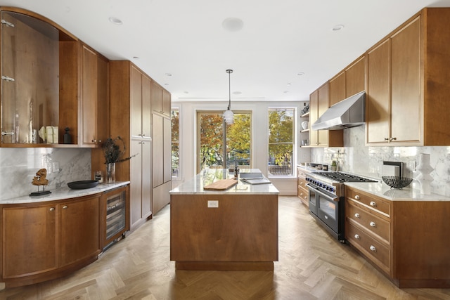 kitchen with range with two ovens, wine cooler, a kitchen island, ventilation hood, and decorative backsplash