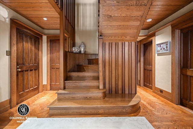 520 E 86th St Unit 1/2C, New York City, NY 10028 - staircase featuring wooden walls, parquet floors, recessed lighting, and wood ceiling