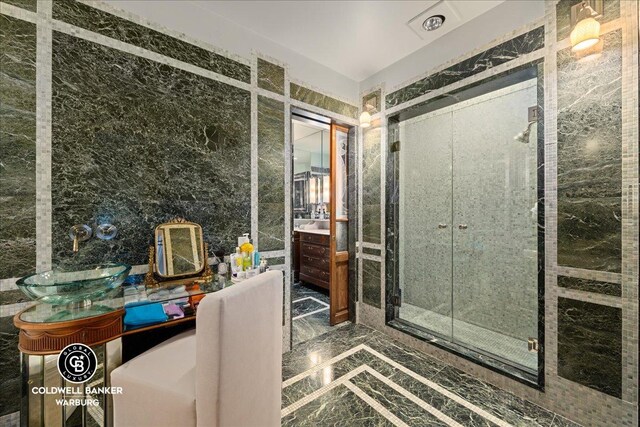 520 E 86th St Unit 1/2C, New York City, NY 10028 - bathroom featuring a shower stall, marble finish floor, and vanity