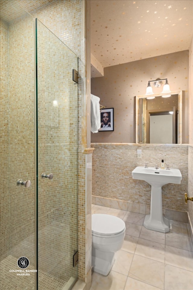 520 E 86th St Unit 1/2C, New York City, NY 10028 - bathroom featuring tile walls, toilet, a wainscoted wall, a stall shower, and tile patterned flooring