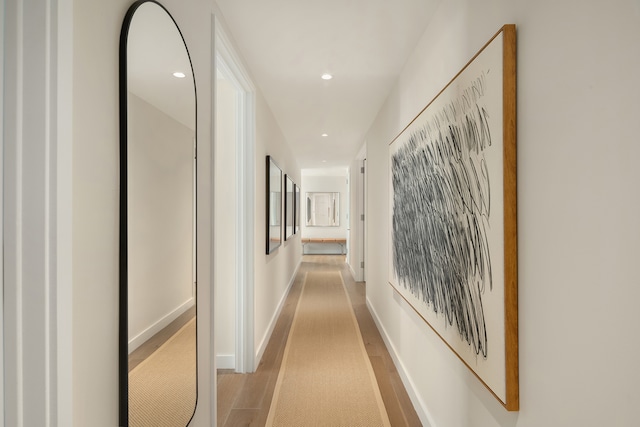 hallway with wood finished floors, recessed lighting, and baseboards