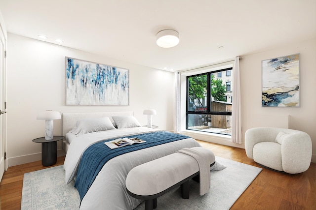 bedroom featuring baseboards and light wood-style floors