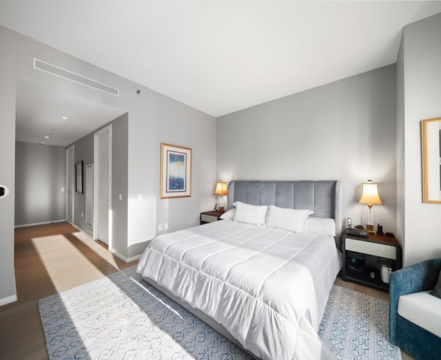 bedroom featuring baseboards and wood finished floors