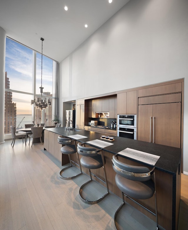kitchen featuring dark countertops, modern cabinets, and floor to ceiling windows