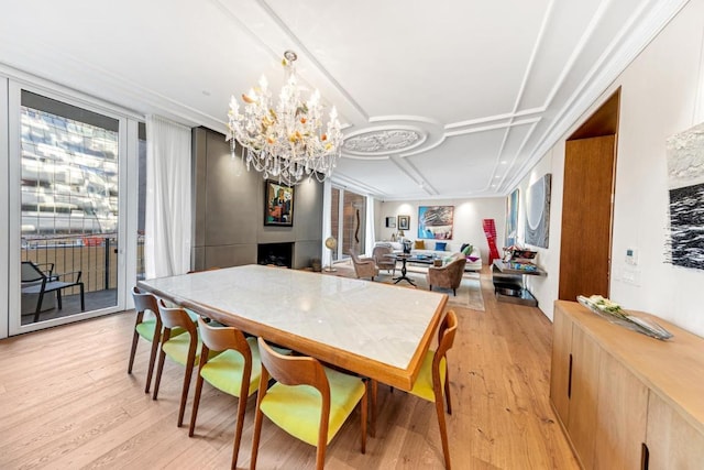 dining room with light hardwood / wood-style floors and a chandelier