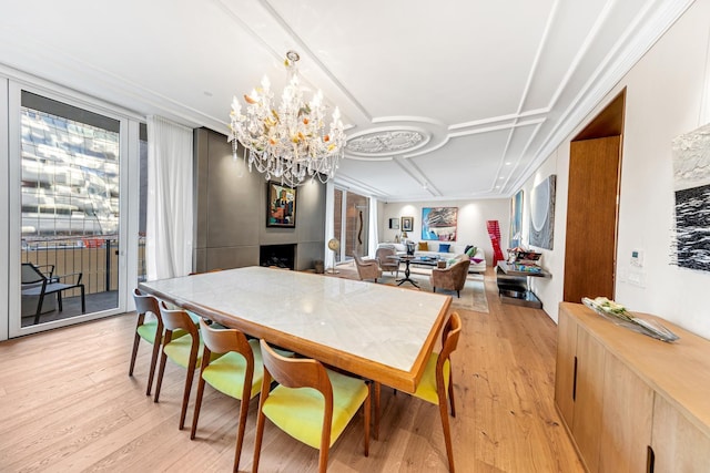 dining room featuring light wood-style floors and an inviting chandelier